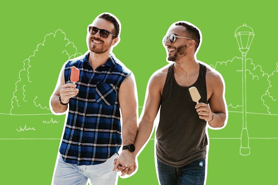 two men smiling and walking with ice cream